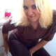 A very pretty blonde girl farts repeatedly while sitting fully clothed on a toilet.